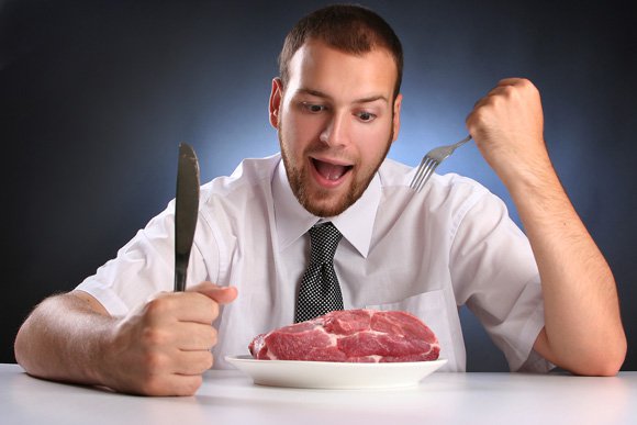 Young Man Eating Raw Meat